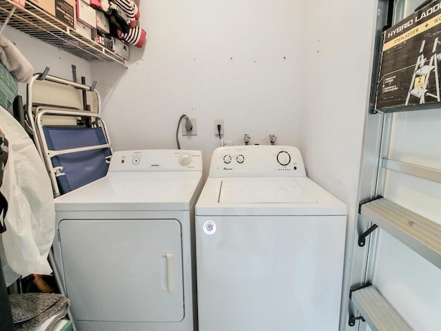 clothes washing area featuring laundry area and separate washer and dryer