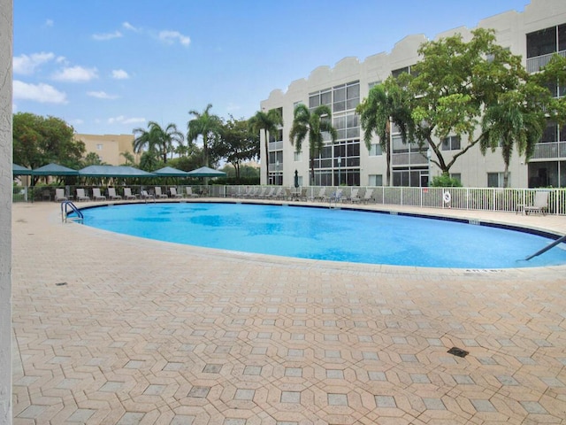 pool featuring a patio area and fence