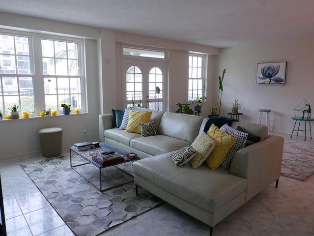 living room with french doors and tile patterned floors