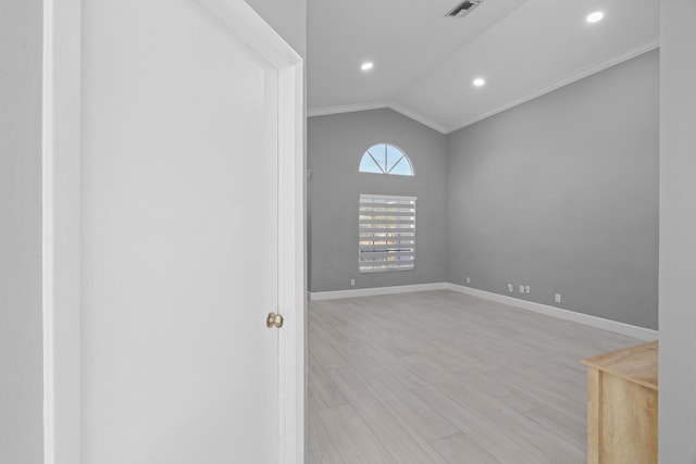 empty room with visible vents, baseboards, lofted ceiling, light wood-type flooring, and recessed lighting