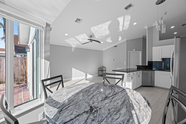 dining space with plenty of natural light, visible vents, and ornamental molding