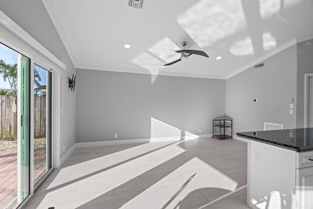 interior space with ornamental molding, white cabinetry, visible vents, and baseboards