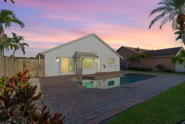 view of pool with a gate, fence, a fenced in pool, and a patio