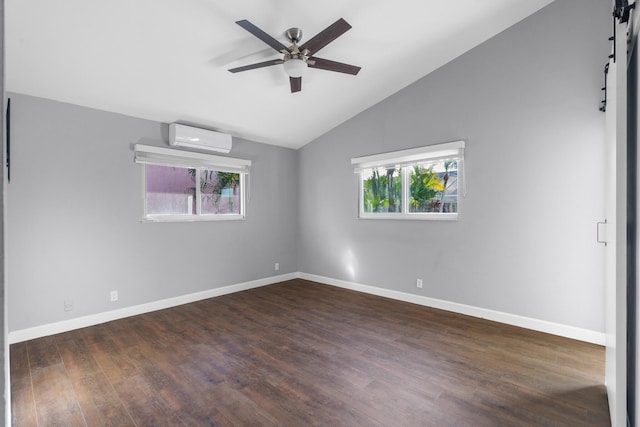 spare room featuring dark wood-style floors, a wall mounted AC, vaulted ceiling, ceiling fan, and baseboards