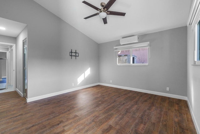 unfurnished room featuring dark wood-type flooring, a wall mounted air conditioner, and baseboards