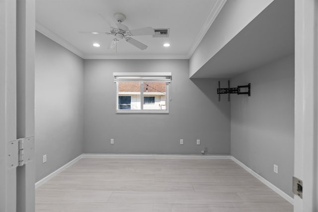 unfurnished room with a ceiling fan, baseboards, visible vents, and crown molding