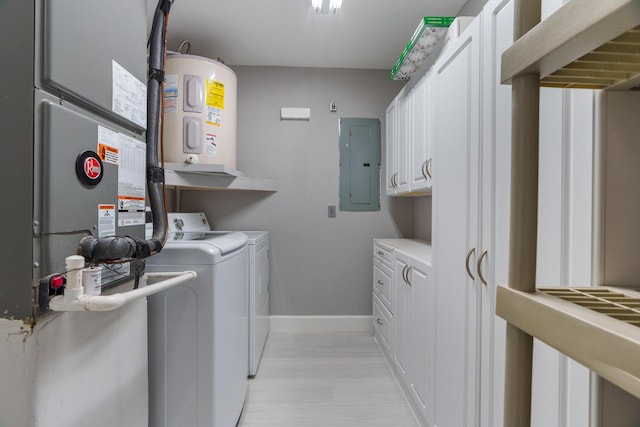 laundry area with cabinet space, electric panel, baseboards, electric water heater, and washing machine and dryer