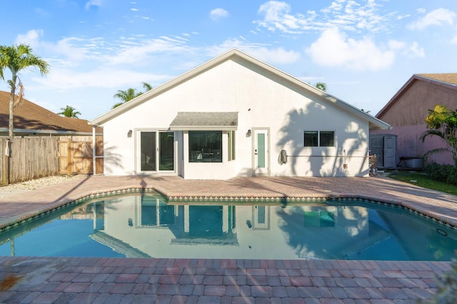 view of swimming pool with a patio area, fence, and a fenced in pool