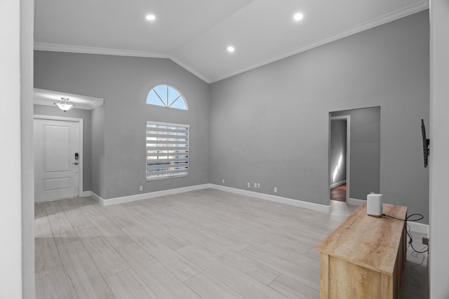 unfurnished room with baseboards, vaulted ceiling, crown molding, light wood-type flooring, and recessed lighting