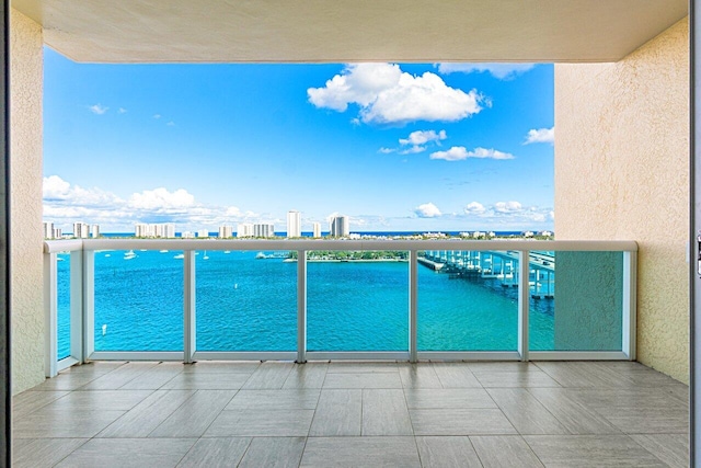 balcony featuring a view of city and a water view