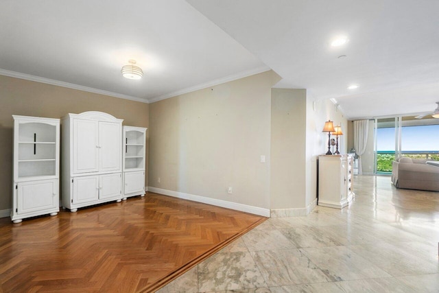 unfurnished room featuring baseboards and ornamental molding