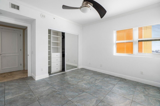 unfurnished bedroom featuring ornamental molding, a closet, visible vents, and baseboards