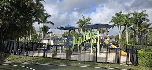 community play area featuring community basketball court and fence