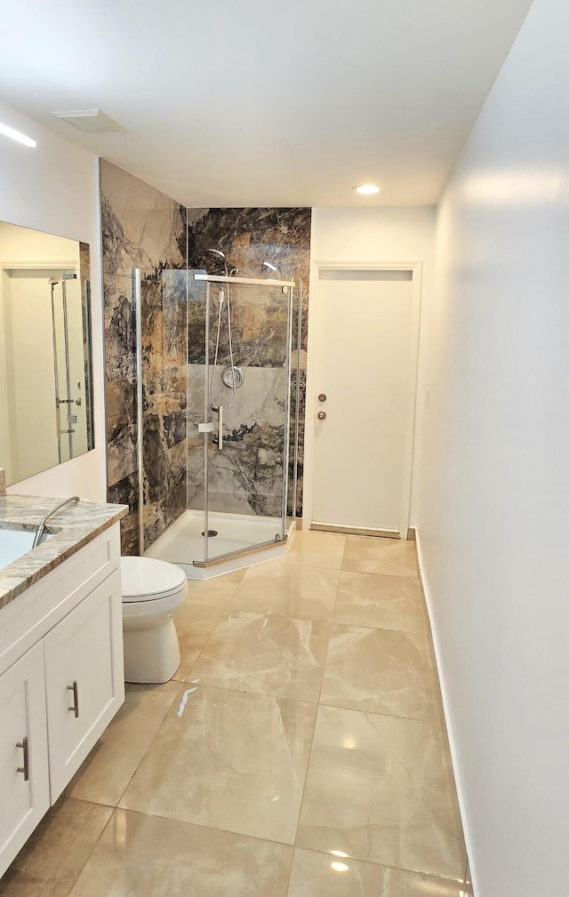 full bathroom featuring marble finish floor, toilet, a shower stall, vanity, and baseboards