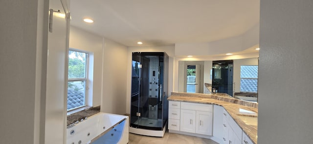 full bath featuring recessed lighting, a shower stall, a tub with jets, and vanity