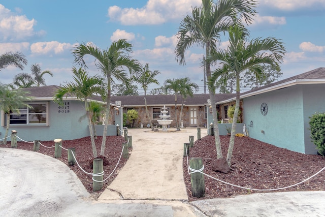 view of front of house featuring concrete driveway and stucco siding