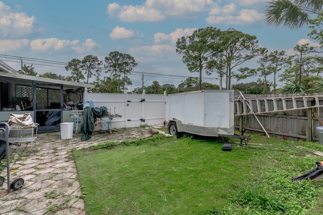 view of yard with a fenced backyard and a gate