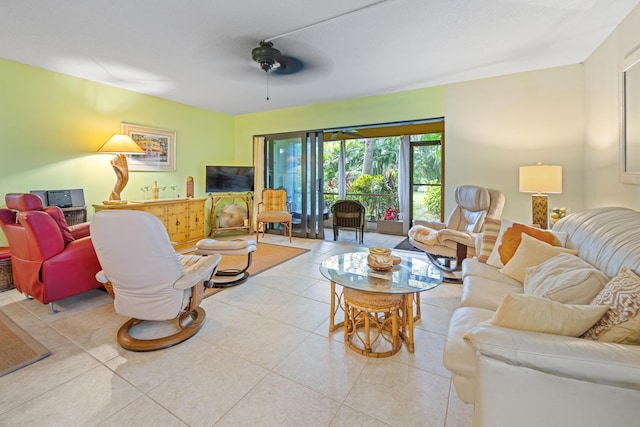 living area with light tile patterned floors and a ceiling fan