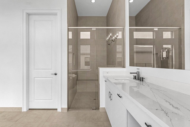 bathroom with recessed lighting, a shower stall, tile patterned flooring, and vanity