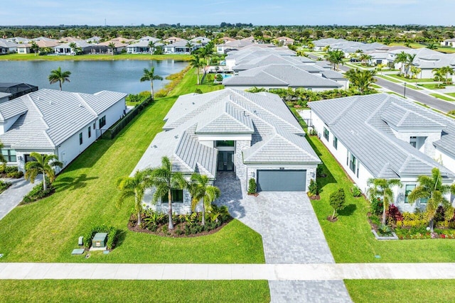 birds eye view of property with a water view and a residential view