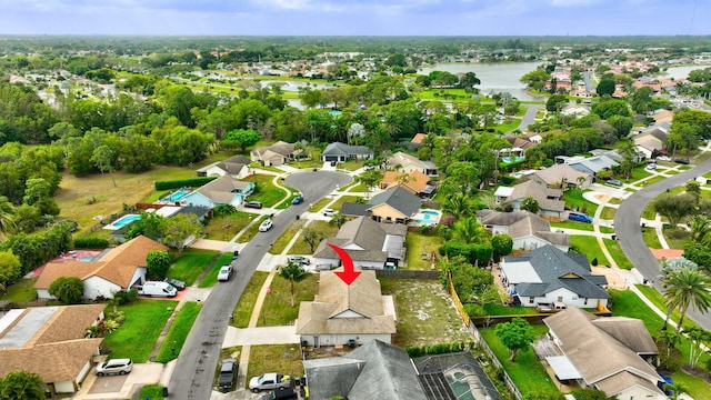 birds eye view of property featuring a water view and a residential view