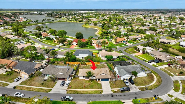 bird's eye view featuring a water view and a residential view