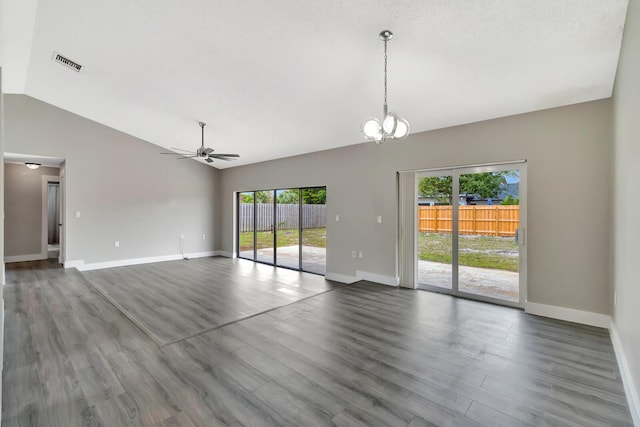 empty room with ceiling fan with notable chandelier, lofted ceiling, visible vents, and wood finished floors