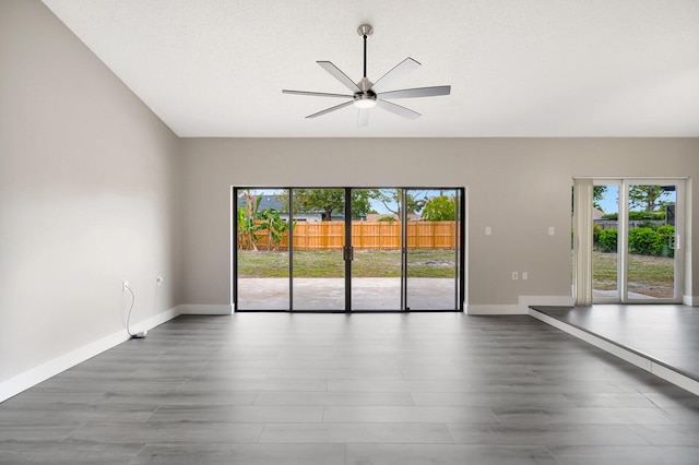 unfurnished room with baseboards, a ceiling fan, and wood finished floors