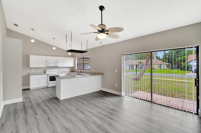 kitchen featuring white appliances, a peninsula, light countertops, light wood-type flooring, and white cabinetry