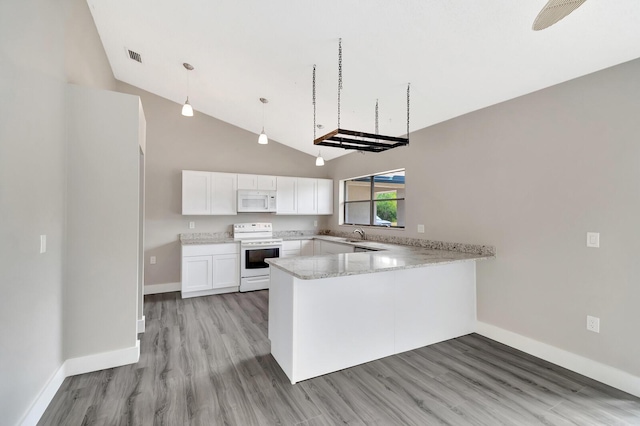 kitchen with light wood-style floors, white appliances, white cabinets, and a peninsula