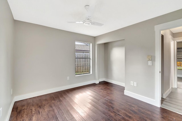 unfurnished room with ceiling fan, baseboards, and wood finished floors