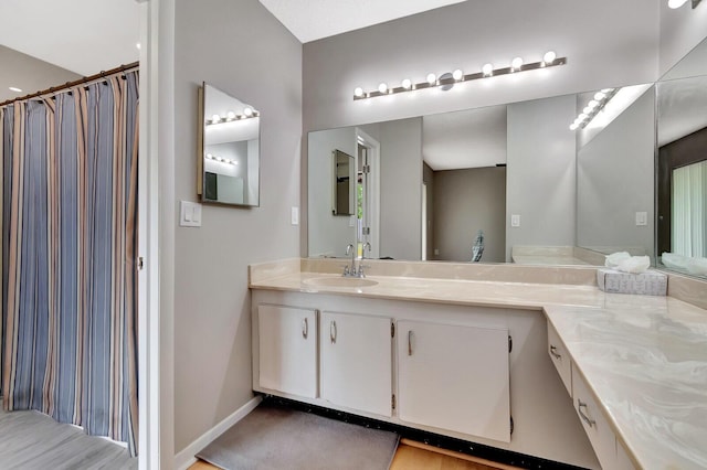 bathroom with baseboards and vanity