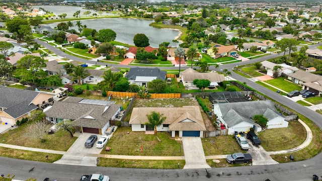 drone / aerial view with a water view and a residential view