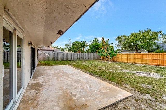 view of yard featuring a patio area and a fenced backyard