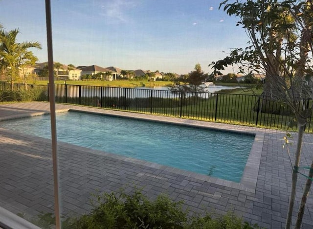 view of pool with a water view, a fenced backyard, and a fenced in pool