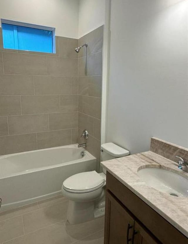 full bath featuring toilet, tile patterned floors, washtub / shower combination, and vanity