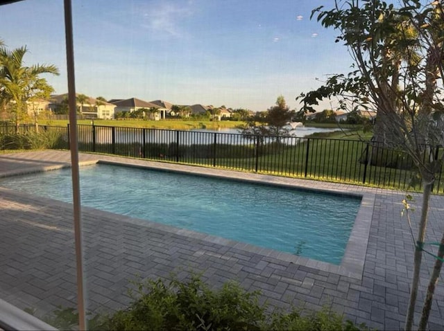 view of swimming pool with a fenced backyard, a residential view, and a fenced in pool