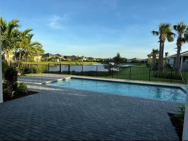 view of pool with a fenced in pool, a patio, a residential view, a water view, and fence