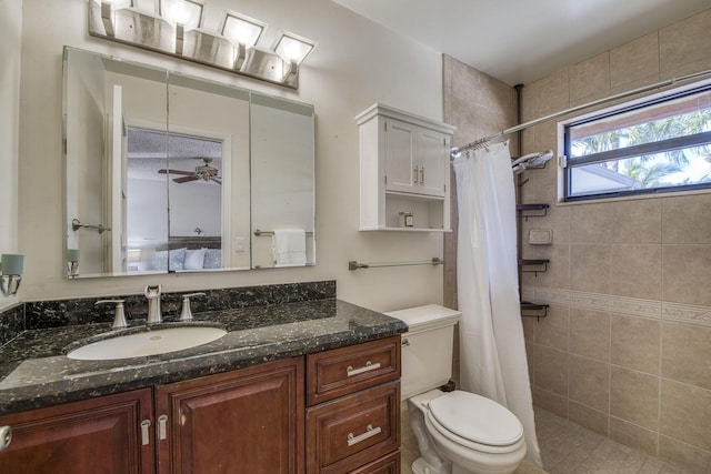 bathroom with tiled shower, vanity, toilet, and ensuite bathroom