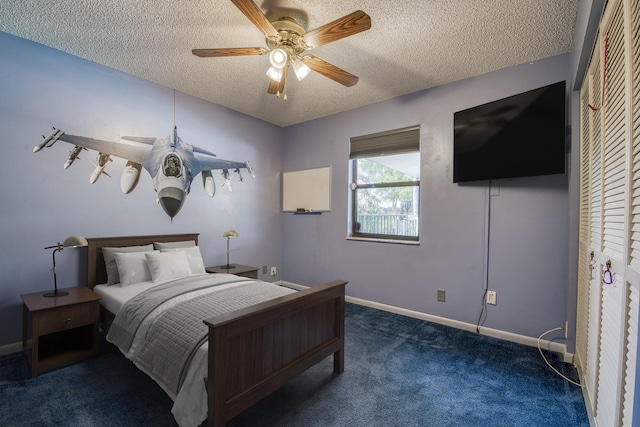 carpeted bedroom featuring a ceiling fan, a textured ceiling, and baseboards