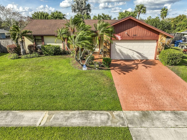 view of front of home with an attached garage, stone siding, decorative driveway, stucco siding, and a front lawn