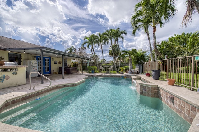 view of pool with a fenced in pool, a jacuzzi, fence, french doors, and a patio area