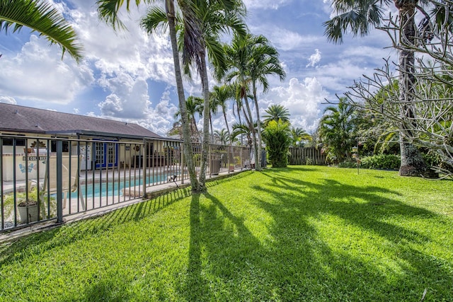 view of yard with fence and a community pool