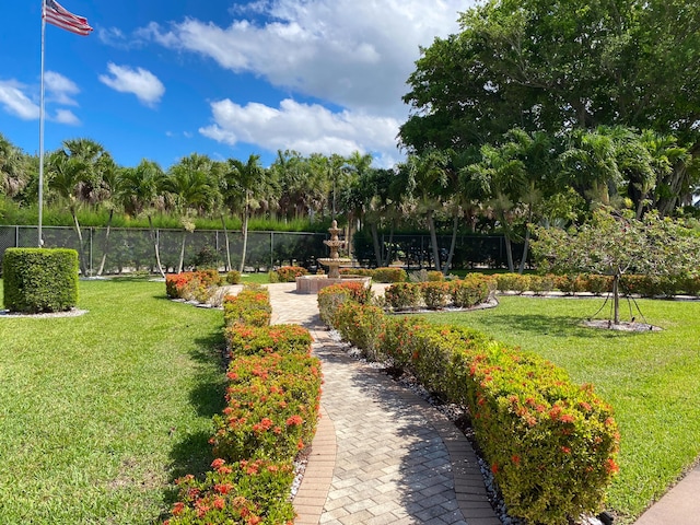 surrounding community featuring fence and a lawn