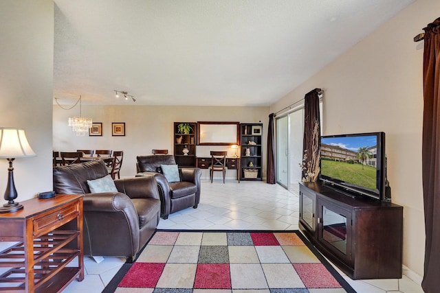 living area featuring baseboards, an inviting chandelier, and light tile patterned floors