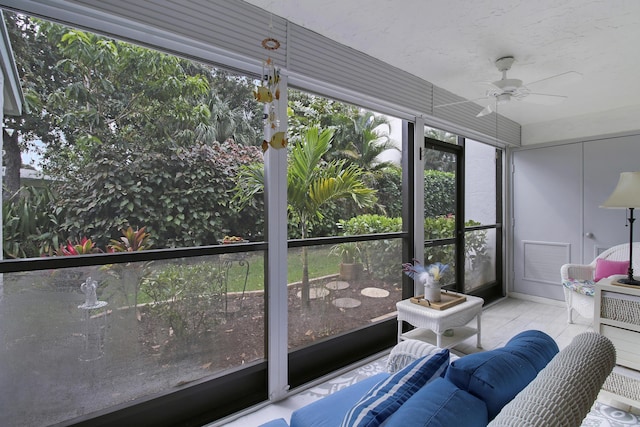 sunroom / solarium featuring ceiling fan