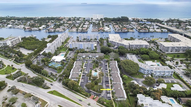 birds eye view of property featuring a water view and a city view