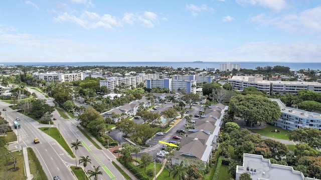 drone / aerial view with a city view and a water view