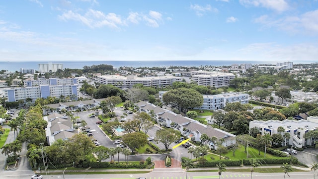 birds eye view of property featuring a water view and a city view