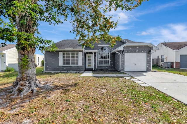 ranch-style house featuring a front yard, concrete driveway, brick siding, and an attached garage